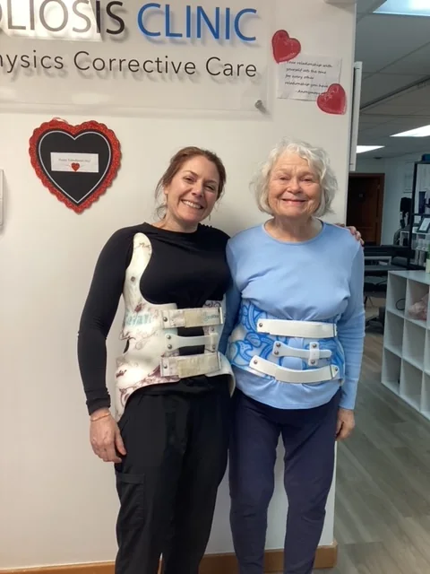 Dr. Johnsen alongside a patient, both wearing braces, at Spine and Scoliosis Clinic