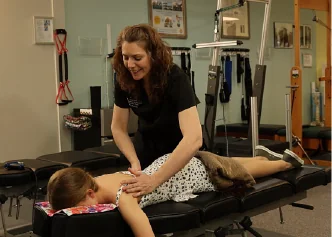 Dr. Elizabeth Johnsen giving a chiropractic adjustment at Spine and Scoliosis Clinic